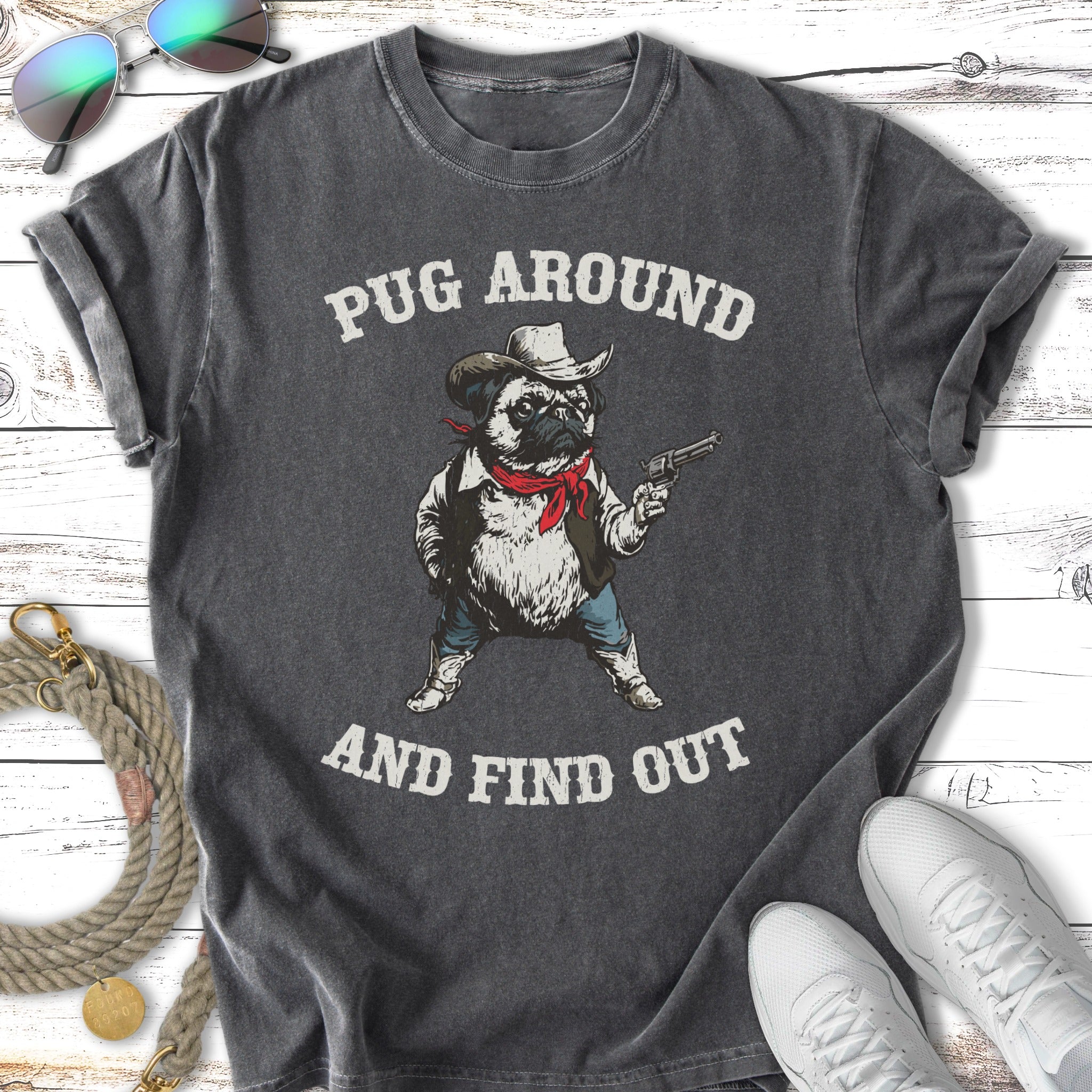Pug in cowboy hat and bandana holding a gun, "Pug Around and Find Out."