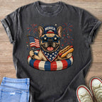 French bulldog with American flag, hot dog, and "Merica" hat on life preserver.