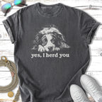 Dark gray t-shirt with a black and white dog's face and "yes, I herd you" text.
