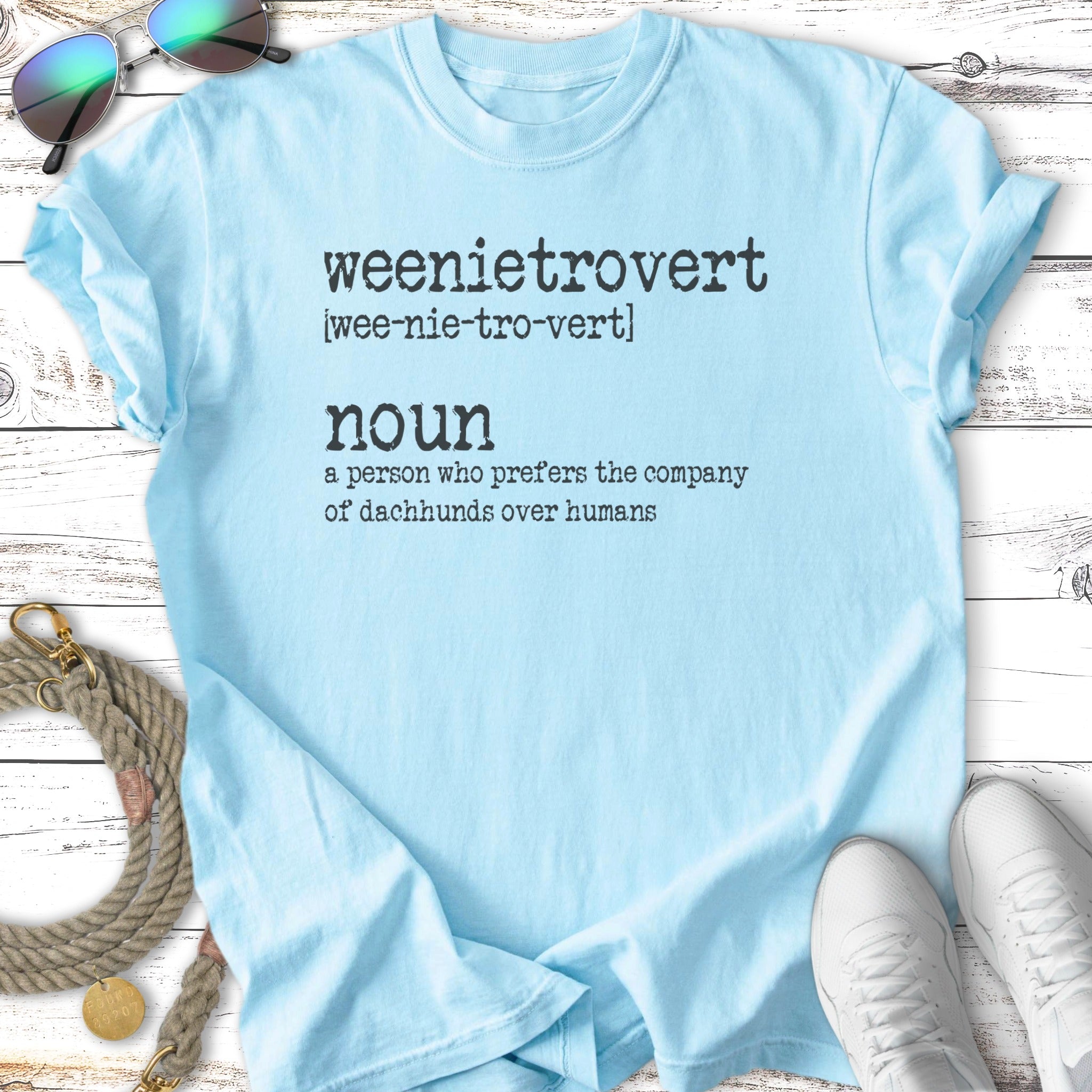 Light blue t-shirt with "weenietrovert noun a person who prefers the company of dachshunds over humans" text.