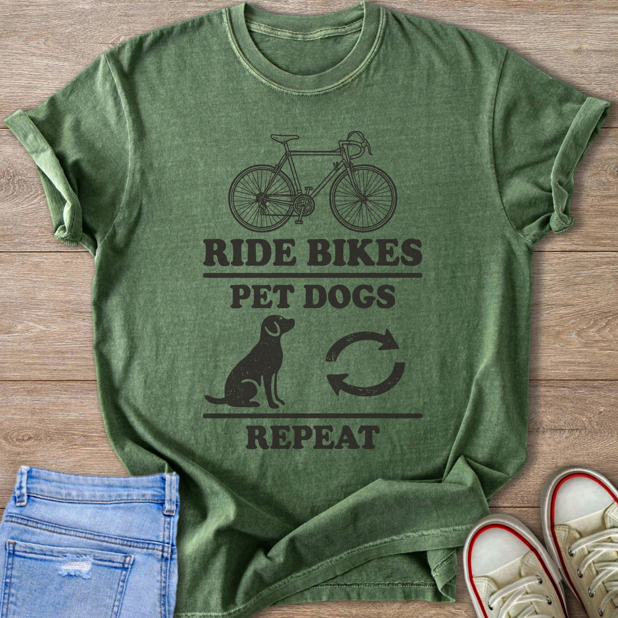 Green t-shirt with bicycle, dog, and text "Ride Bikes Pet Dogs Repeat" graphic.