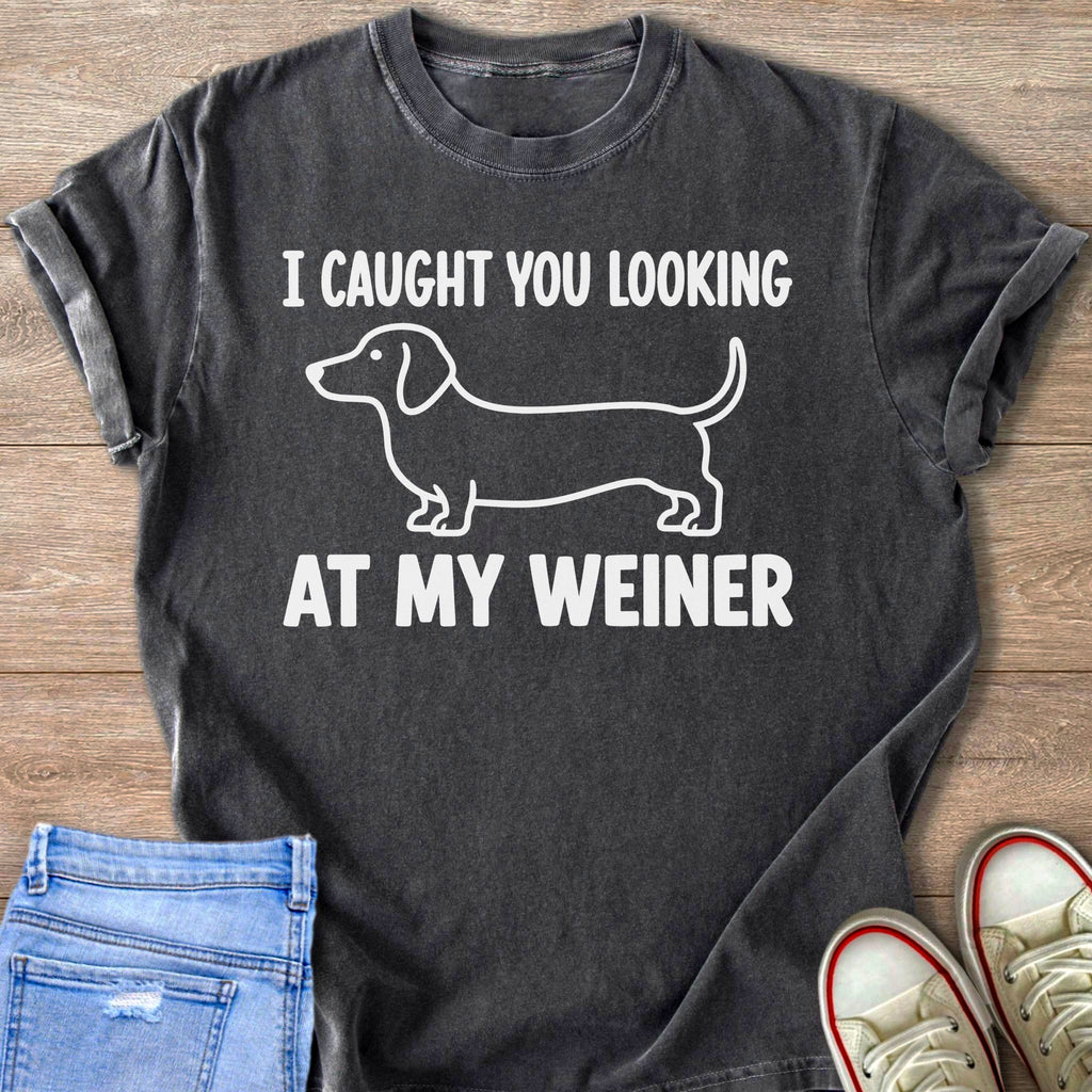 Dark t-shirt with white text "I CAUGHT YOU LOOKING AT MY WEINER" and a dachshund outline.