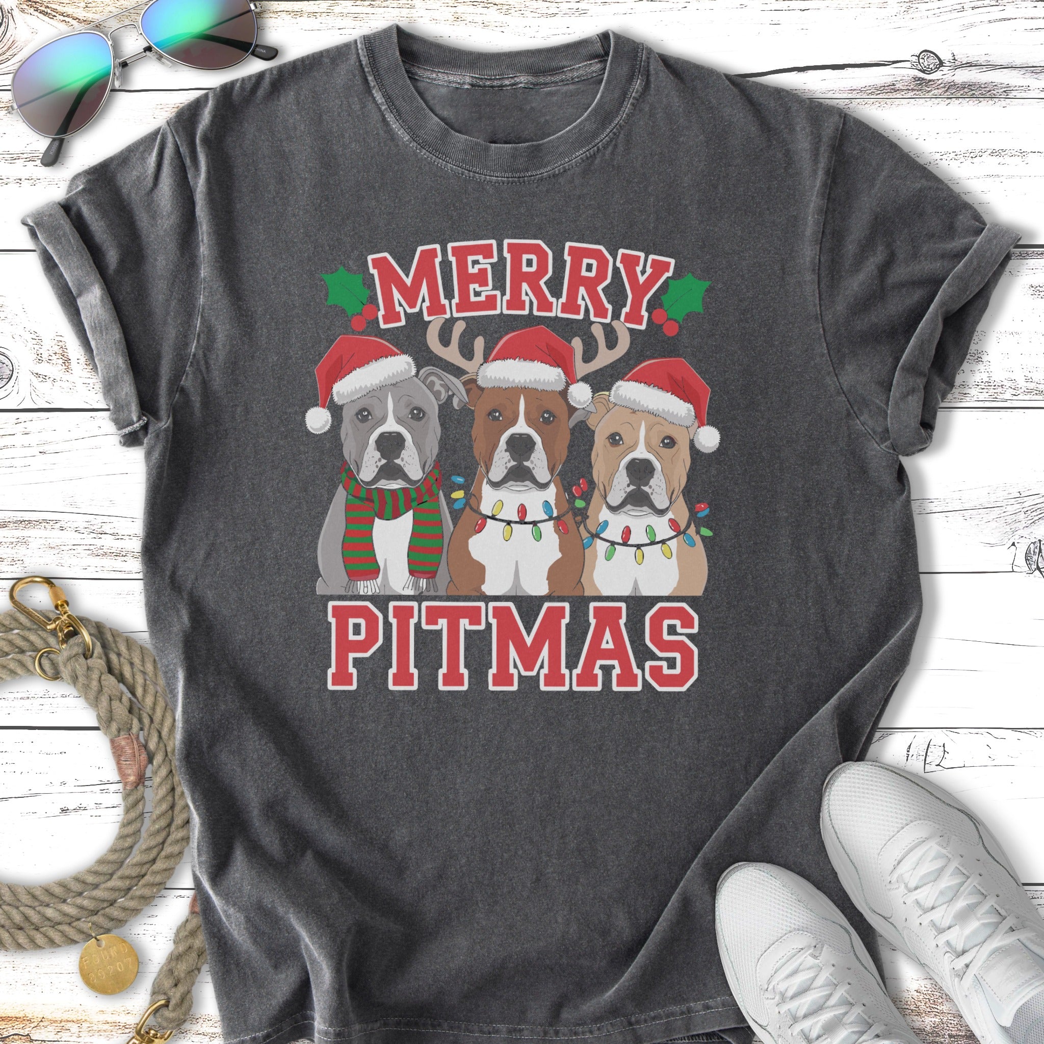 Three pitbulls in Santa hats and Christmas lights, text "MERRY PITMAS".