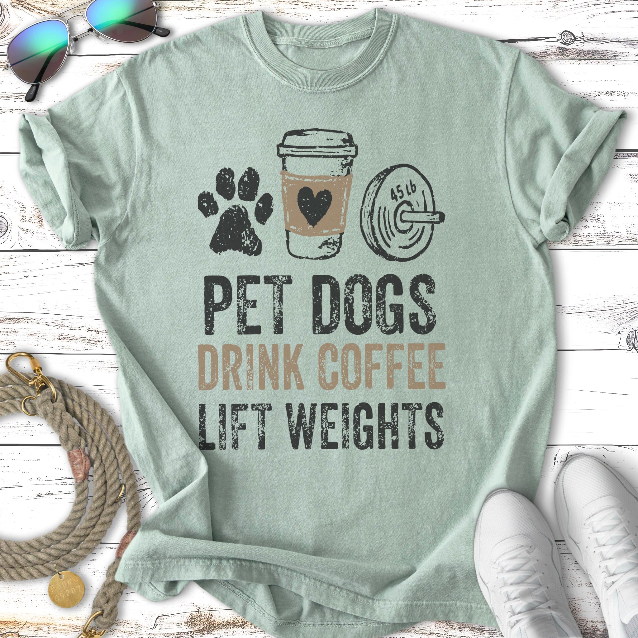 T-shirt with text "PET DOGS DRINK COFFEE LIFT WEIGHTS".