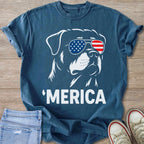 Rottweiler wearing American flag sunglasses and text 'MERICA on a blue t-shirt.