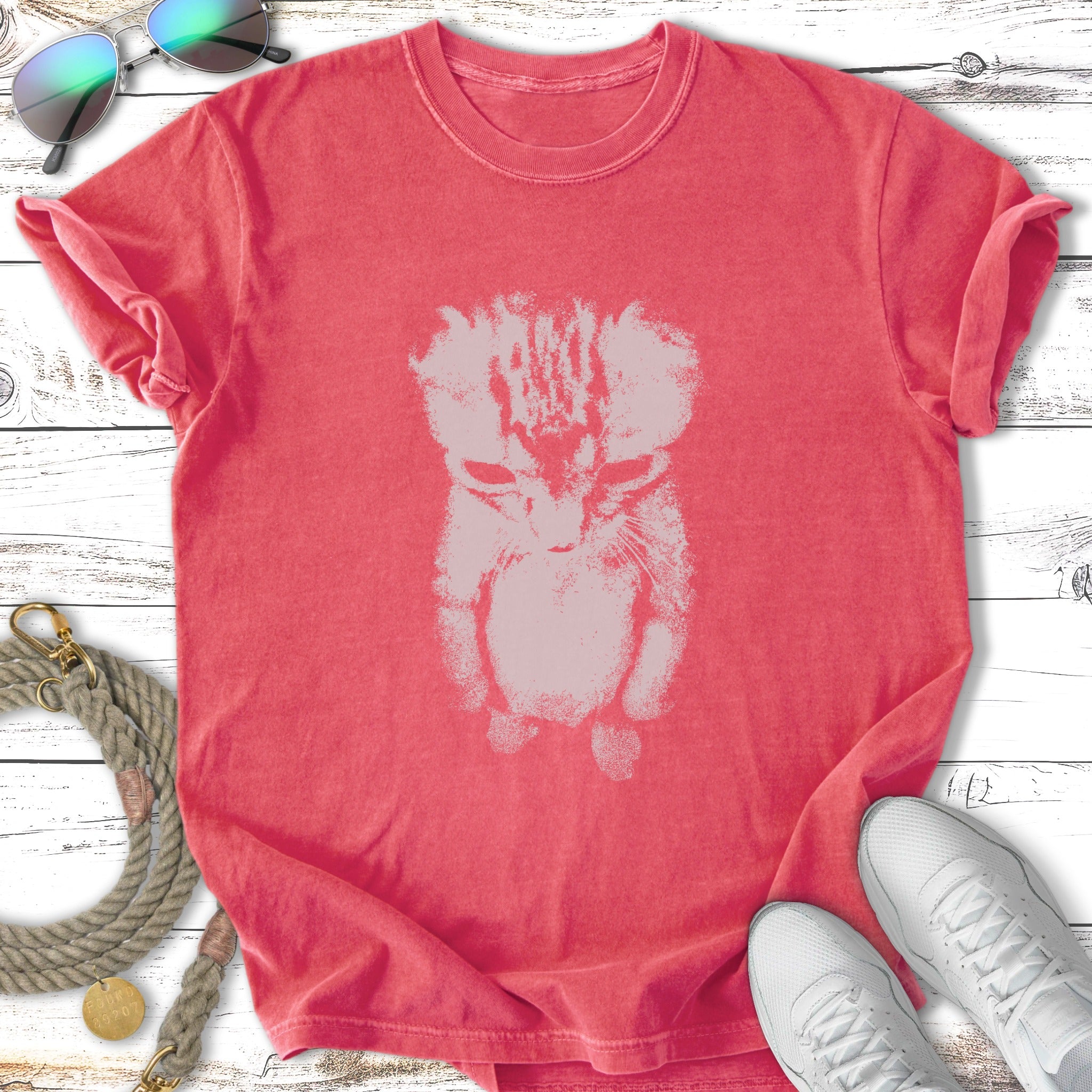 T-shirt with distressed cat graphic in a pale pink color.