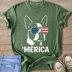 Green t-shirt with white outline of French bulldog wearing US flag sunglasses, text 'MERICA.