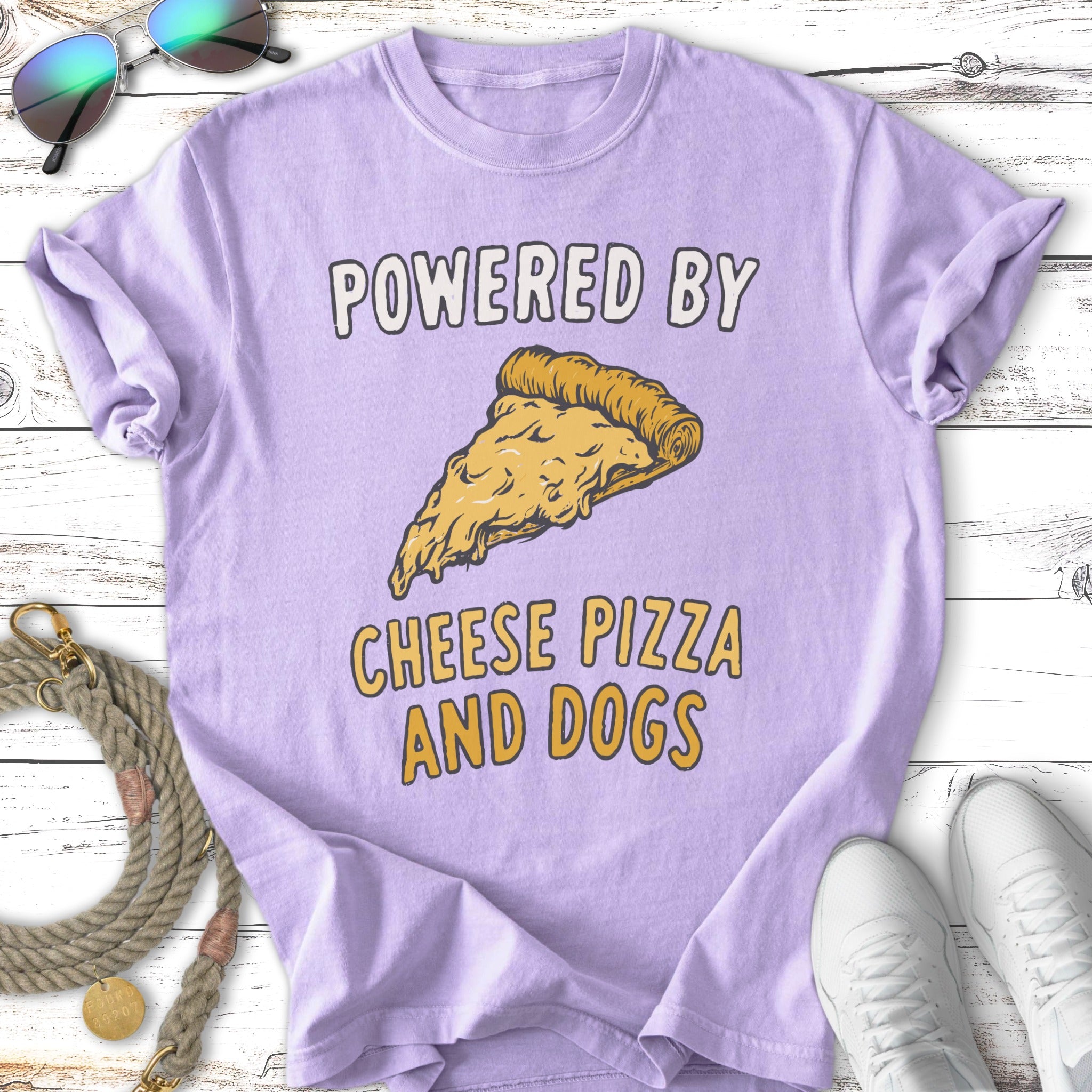Lavender t-shirt with "Powered by Cheese Pizza and Dogs" and pizza slice graphic.