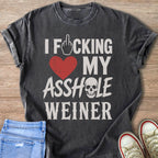 Dark grey t-shirt with text "I F_CKING LOVE MY ASSHOLE WEINER".