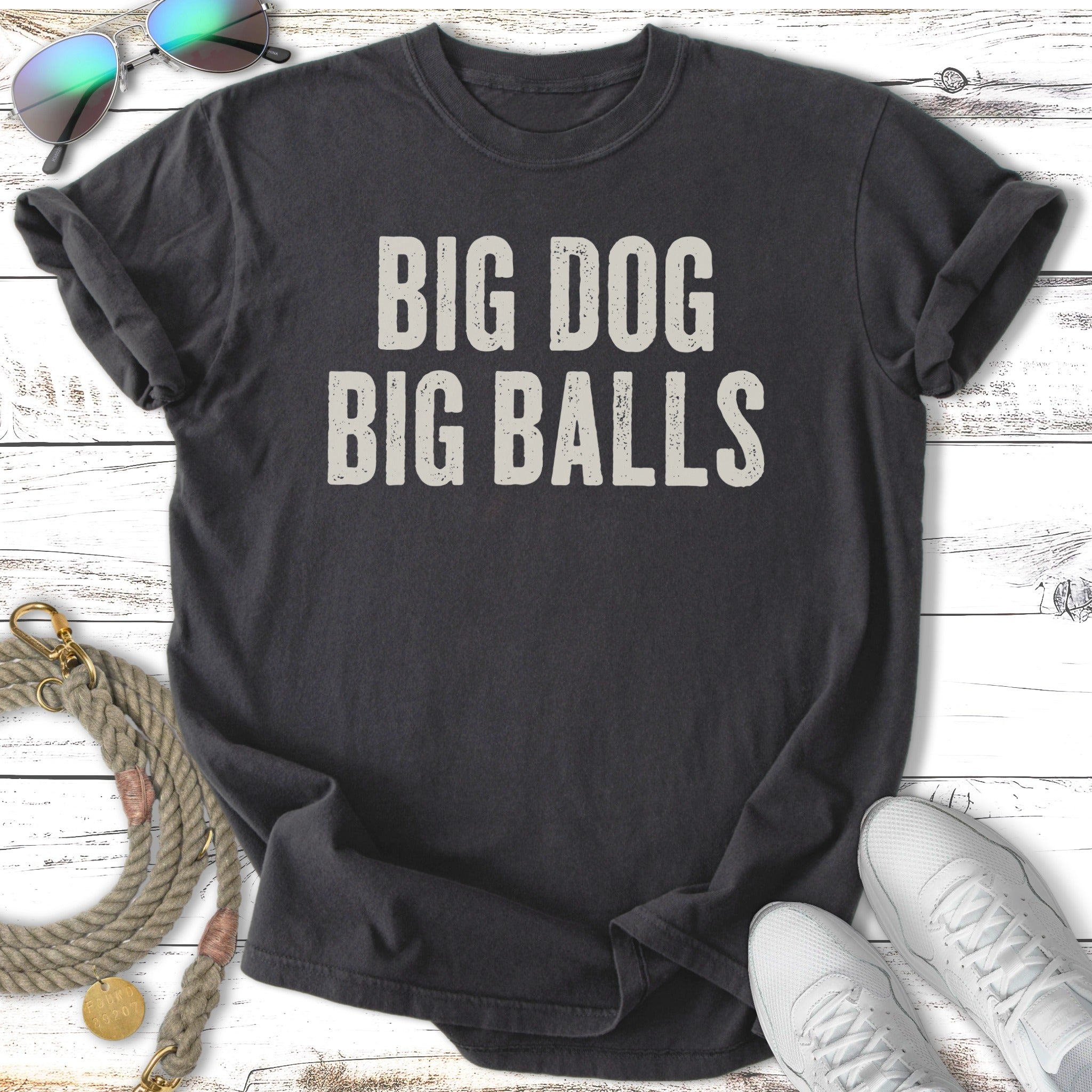 Dark t-shirt with "BIG DOG BIG BALLS" text and sunglasses and shoes.
