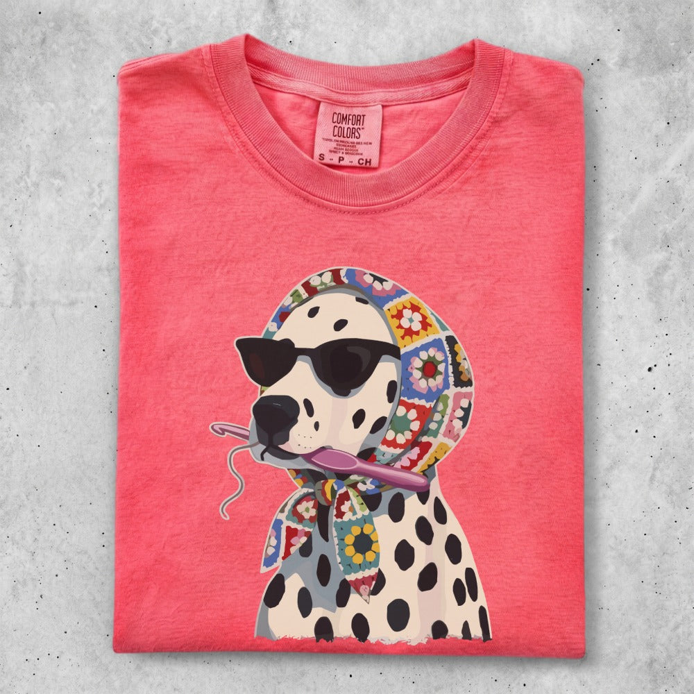 Dalmatian wearing sunglasses and a crochet scarf holding crochet hook.