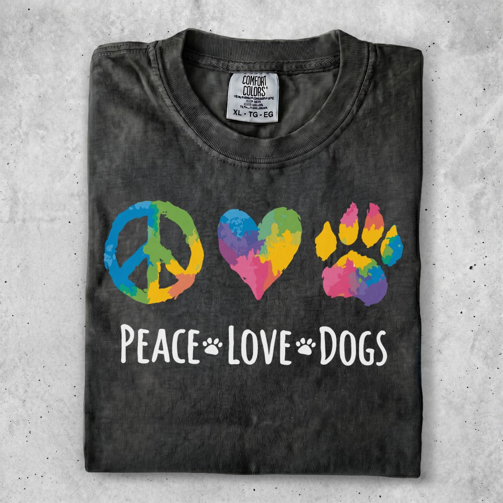 Peace, love, dogs graphic t-shirt with colorful symbols and text.