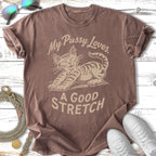 T-shirt with graphic of a cat stretching and text "My Pussy Loves A GOOD STRETCH".