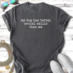Black t-shirt with "my dog has better social skills than me" text.
