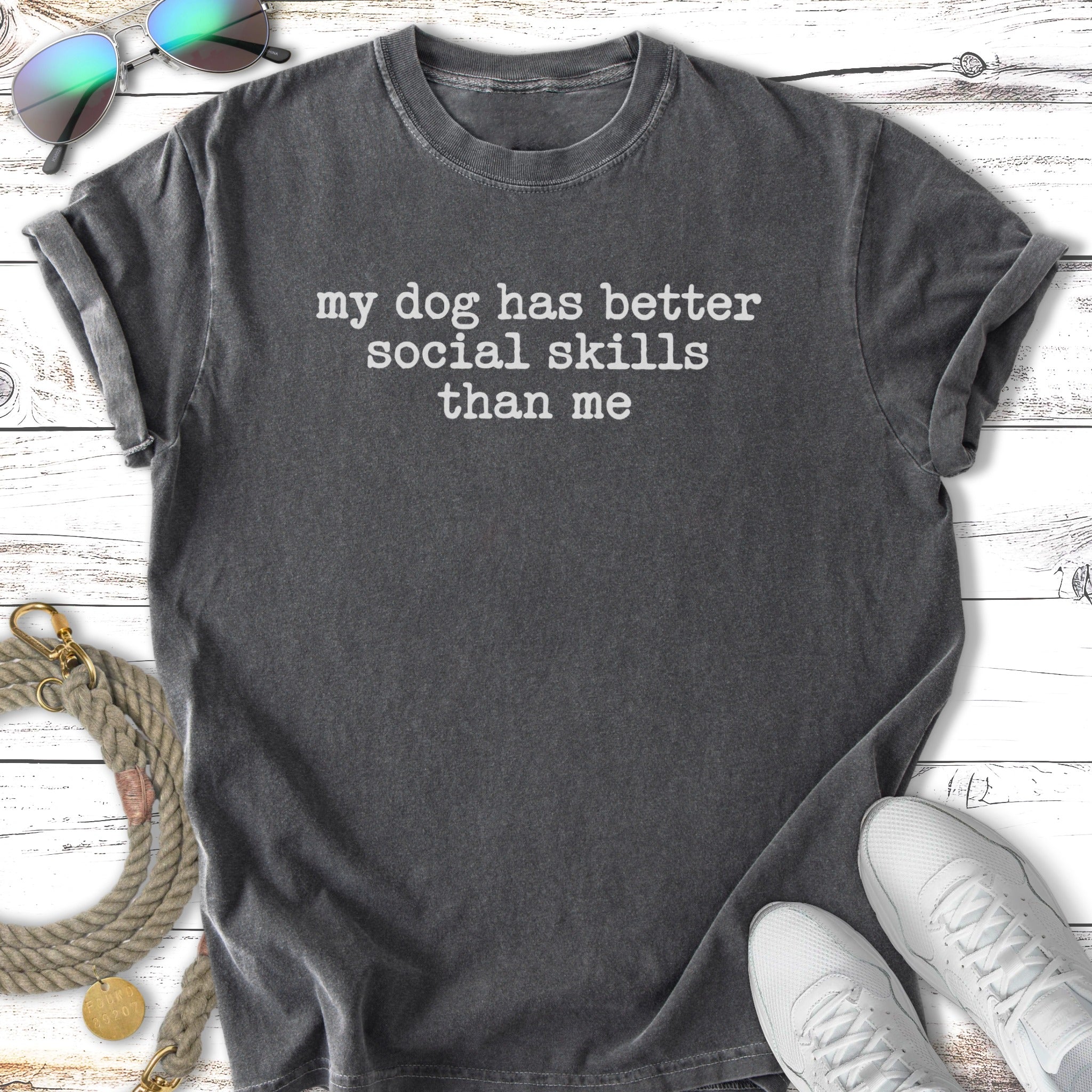 Black t-shirt with "my dog has better social skills than me" text.