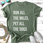 Green t-shirt with "Run All The Miles, Pet All The Dogs" text.