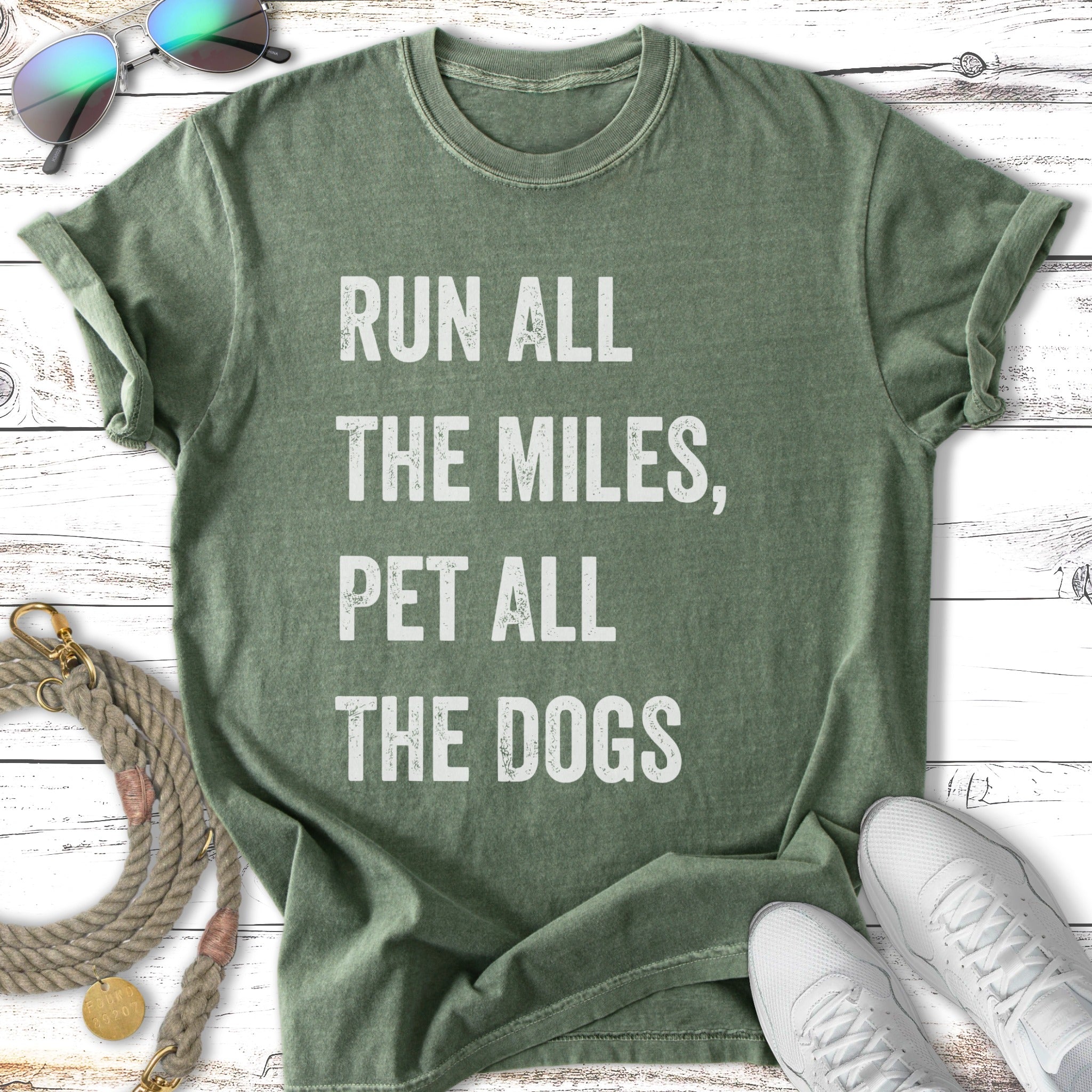 Green t-shirt with "Run All The Miles, Pet All The Dogs" text.