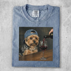 T-shirt featuring a painting of a dog wearing a baseball cap pouring red wine.