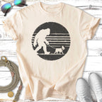 Cream t-shirt with Bigfoot walking a French bulldog on a leash.