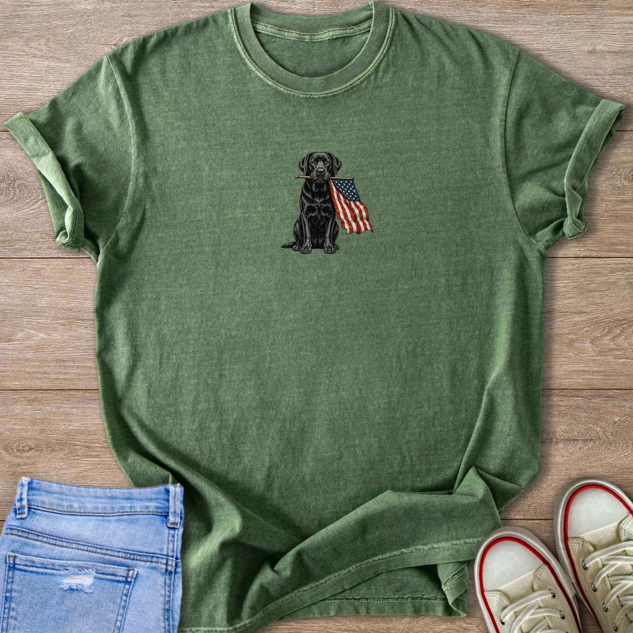 Green t-shirt with a black Labrador holding an American flag in its mouth.