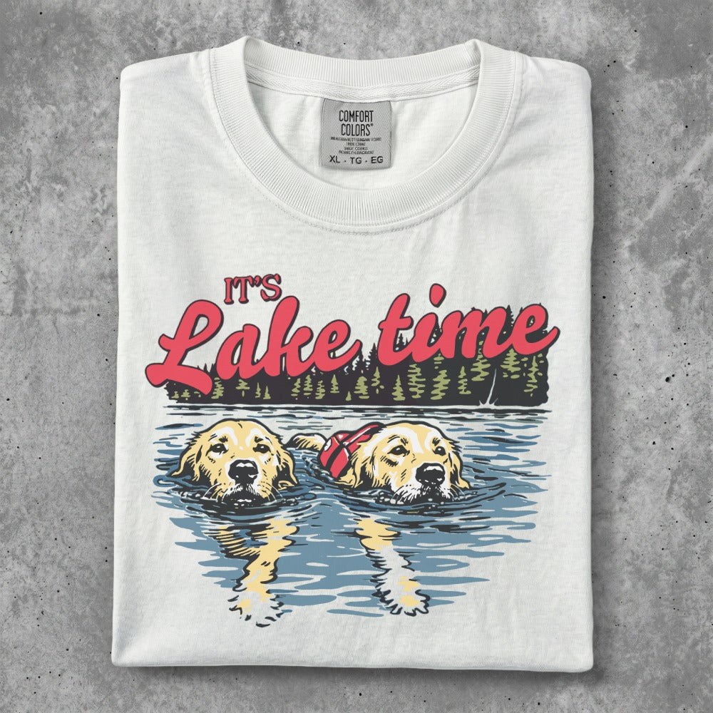 White t-shirt with "It's Lake time" text and two golden retrievers swimming.
