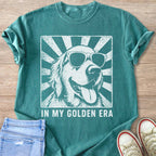 T-shirt with a graphic of a golden retriever wearing sunglasses and text "IN MY GOLDEN ERA".