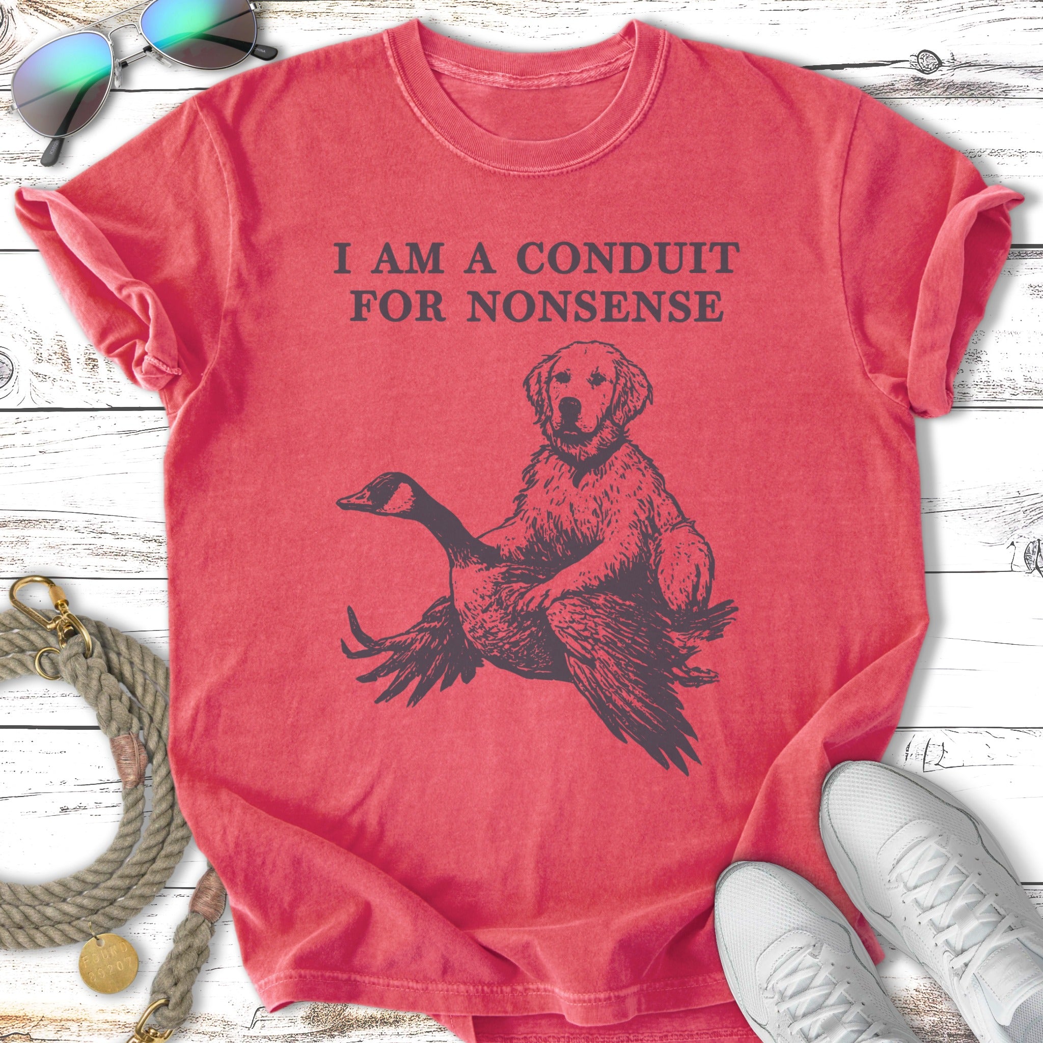 Distressed t-shirt with graphic of a dog on a goose, text reads "I AM A CONDUIT FOR NONSENSE".