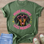 Green t-shirt with dachshund wearing heart sunglasses and text "More Weenies Less Meanies."