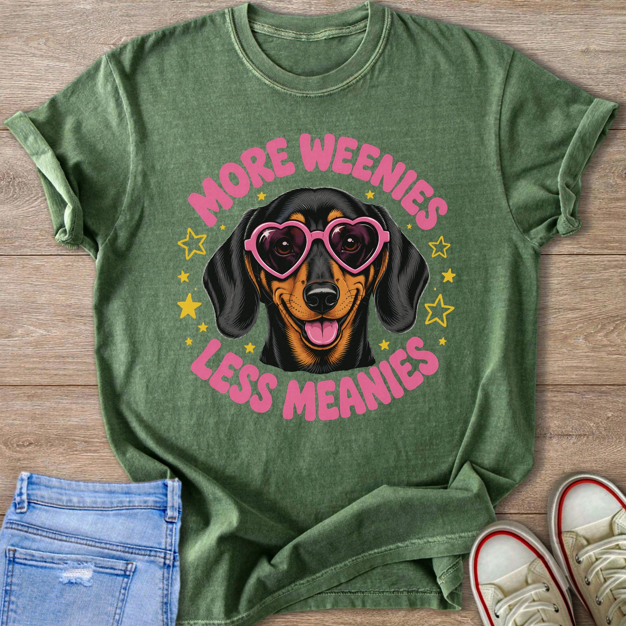 Green t-shirt with dachshund wearing heart sunglasses and text "More Weenies Less Meanies."