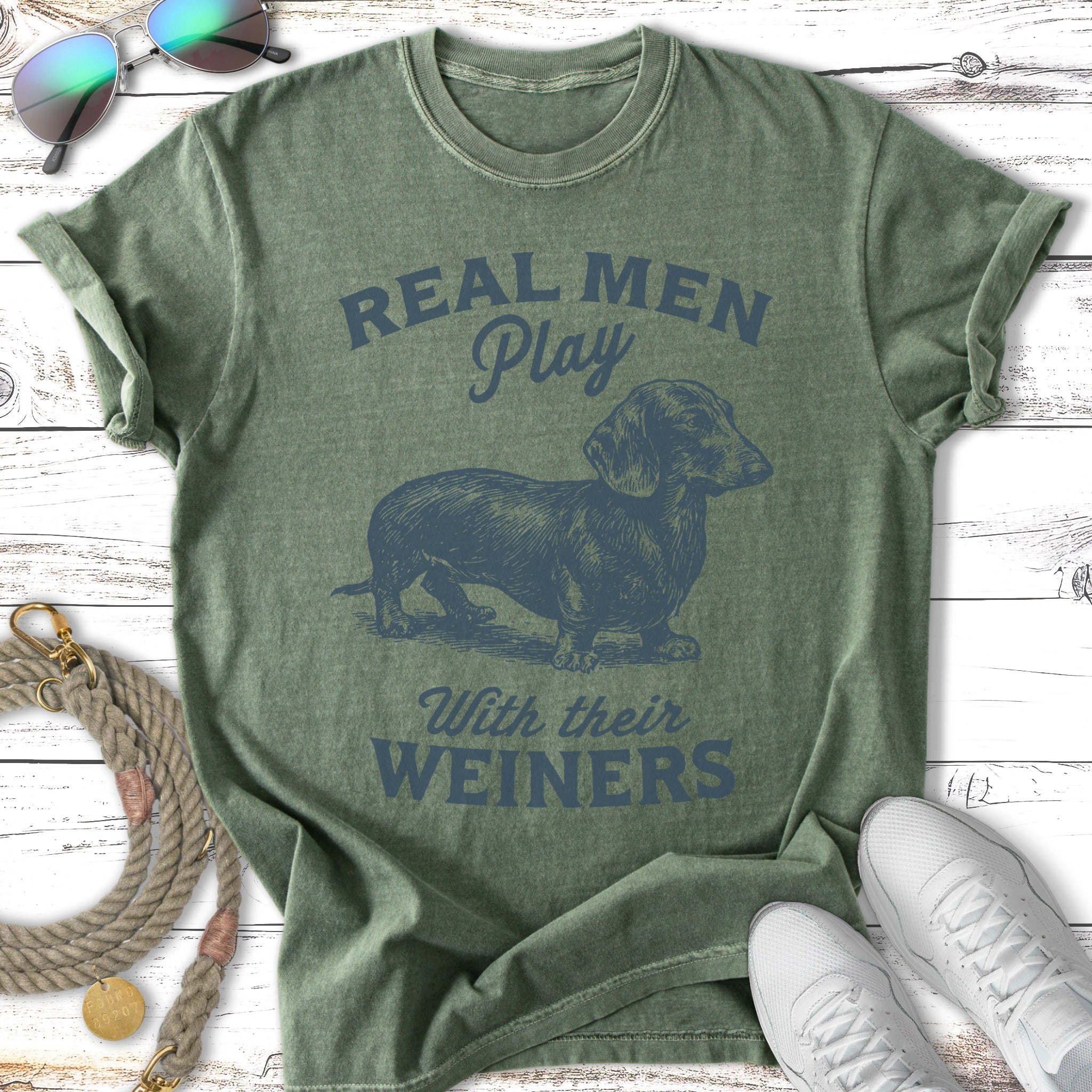Green t-shirt with "Real Men Play With Their Weiners" and a dachshund graphic.