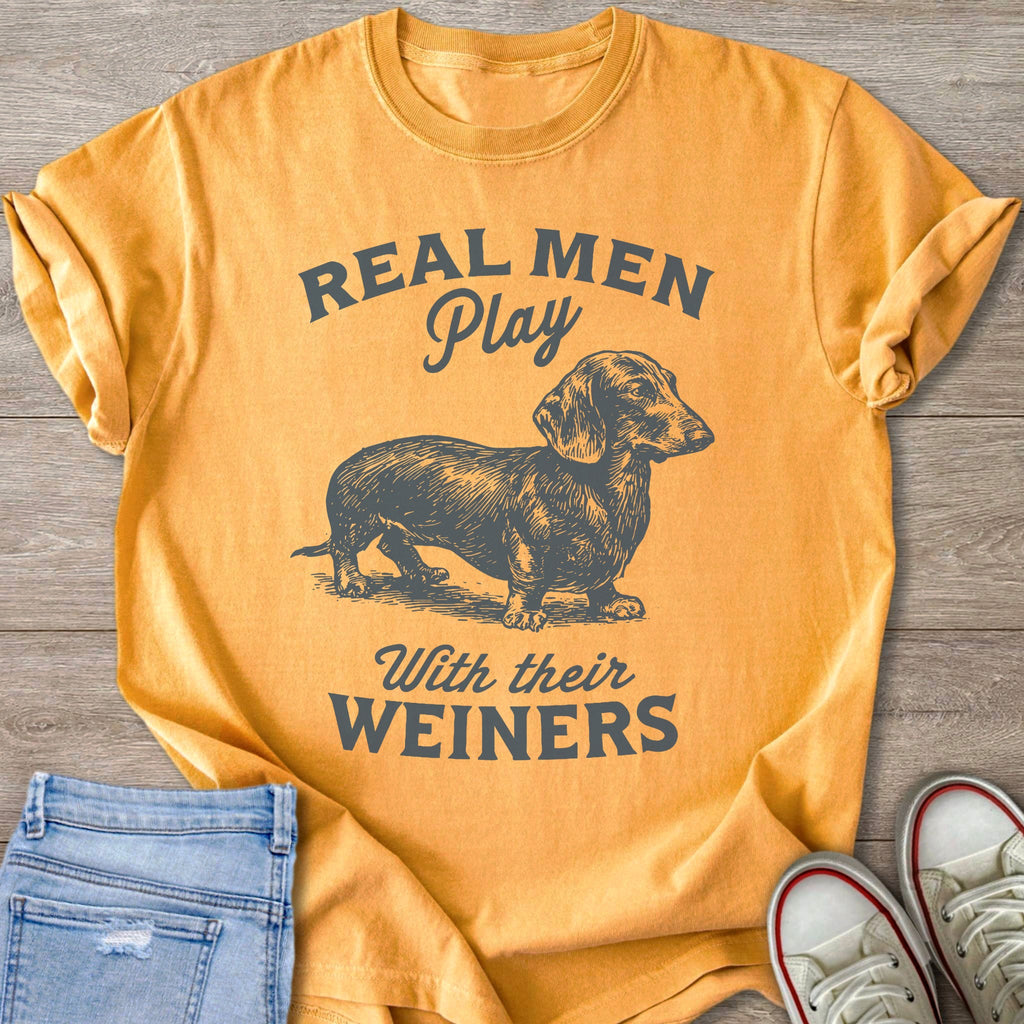 Orange t-shirt with grey text "REAL MEN Play With their WEINERS" and a dachshund illustration.