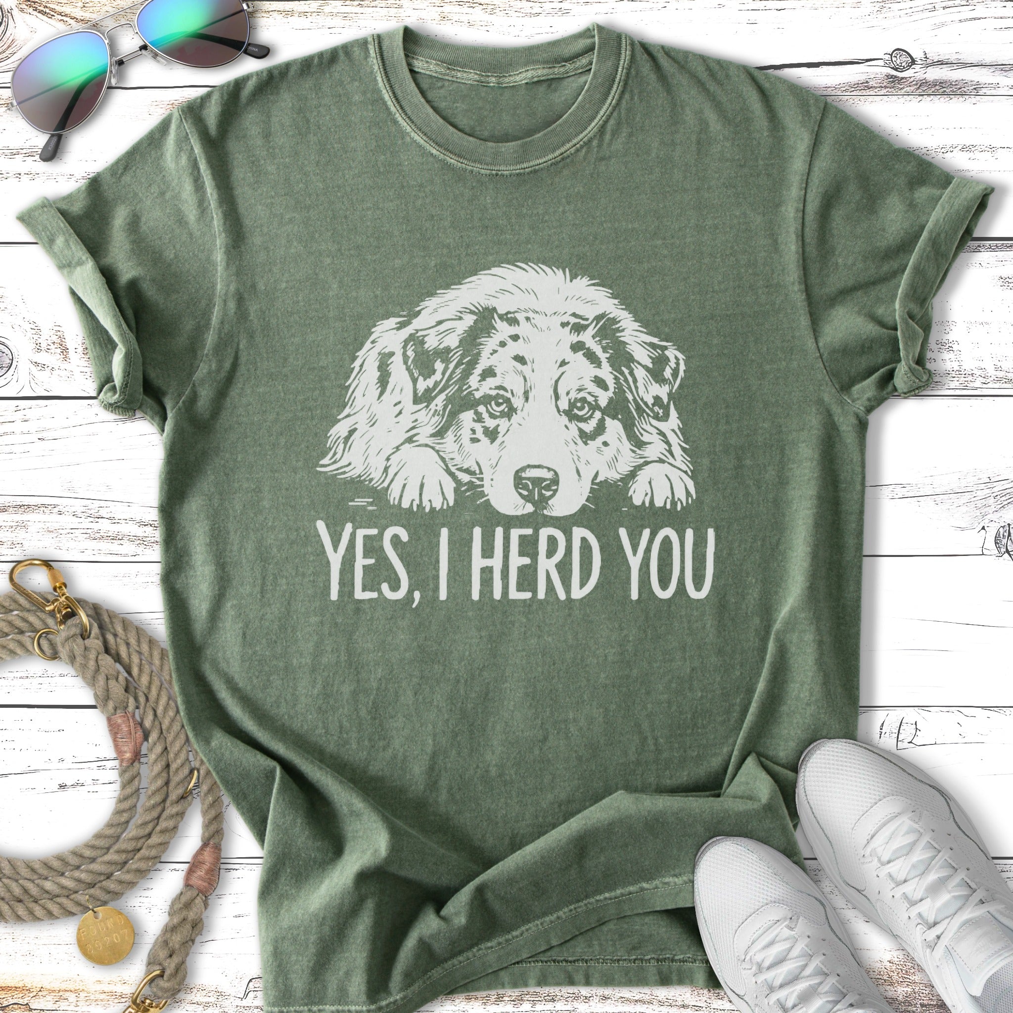 Green t-shirt with a faded dog graphic and text "YES, I HERD YOU".