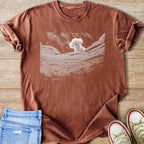 Espresso Comfort Colors T-shirt with a graphic of a white poodle, precious. from a in silence of the lambs scene peeking over a rocky well.