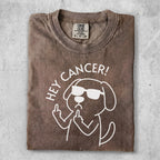 Brown t-shirt with a cartoon dog wearing sunglasses giving the middle finger and saying "Hey Cancer!"
