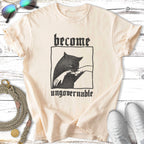 Cream t-shirt with black graphic: a cat's paw reaching up, text "become ungovernable".