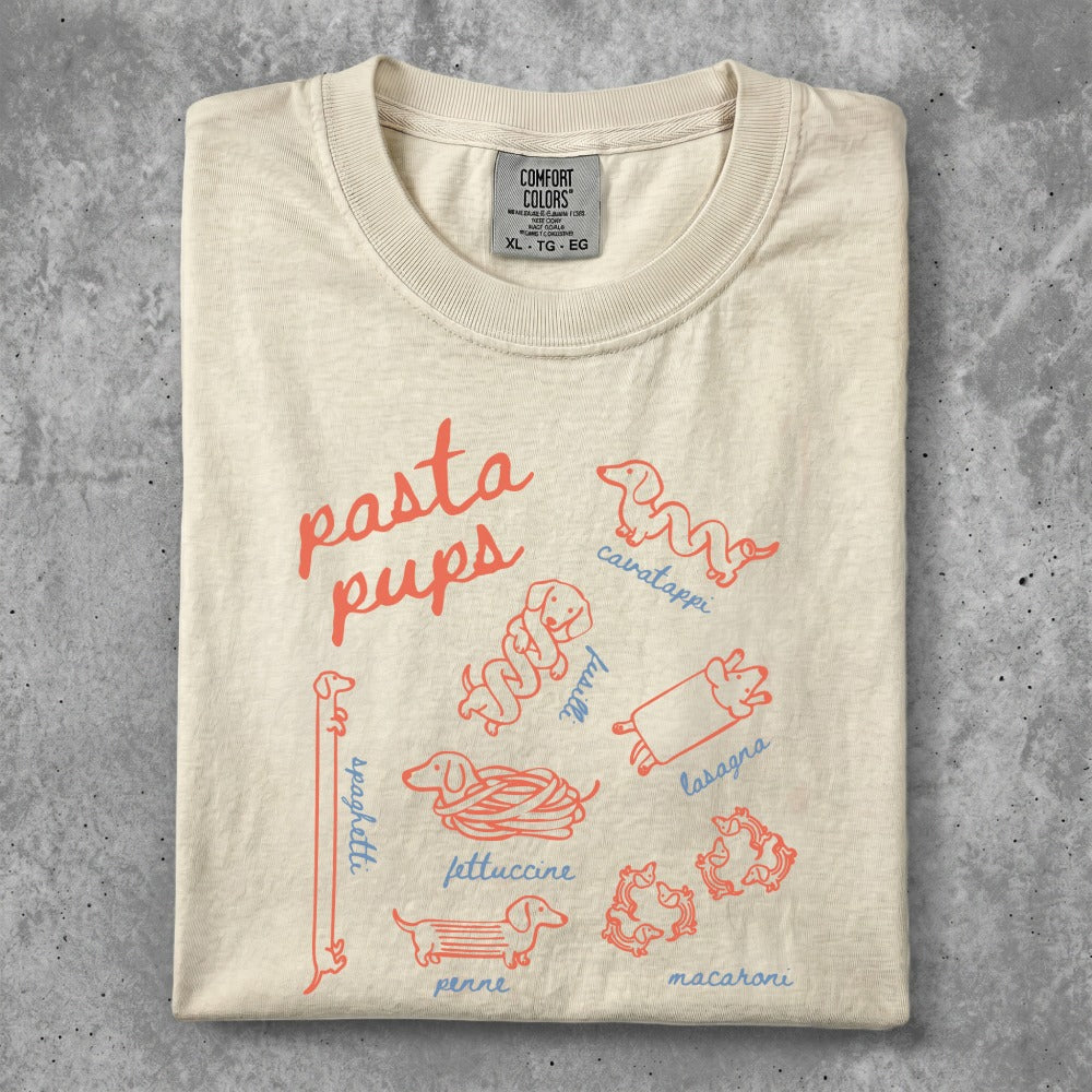 Cream t-shirt with playful pasta-themed dog illustrations and text.