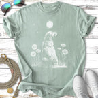 White outline of a dog sitting in grass with daisies under a moon.