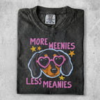Dark t-shirt with a dachshund wearing pink heart sunglasses and text "More Weenies Less Meanies".