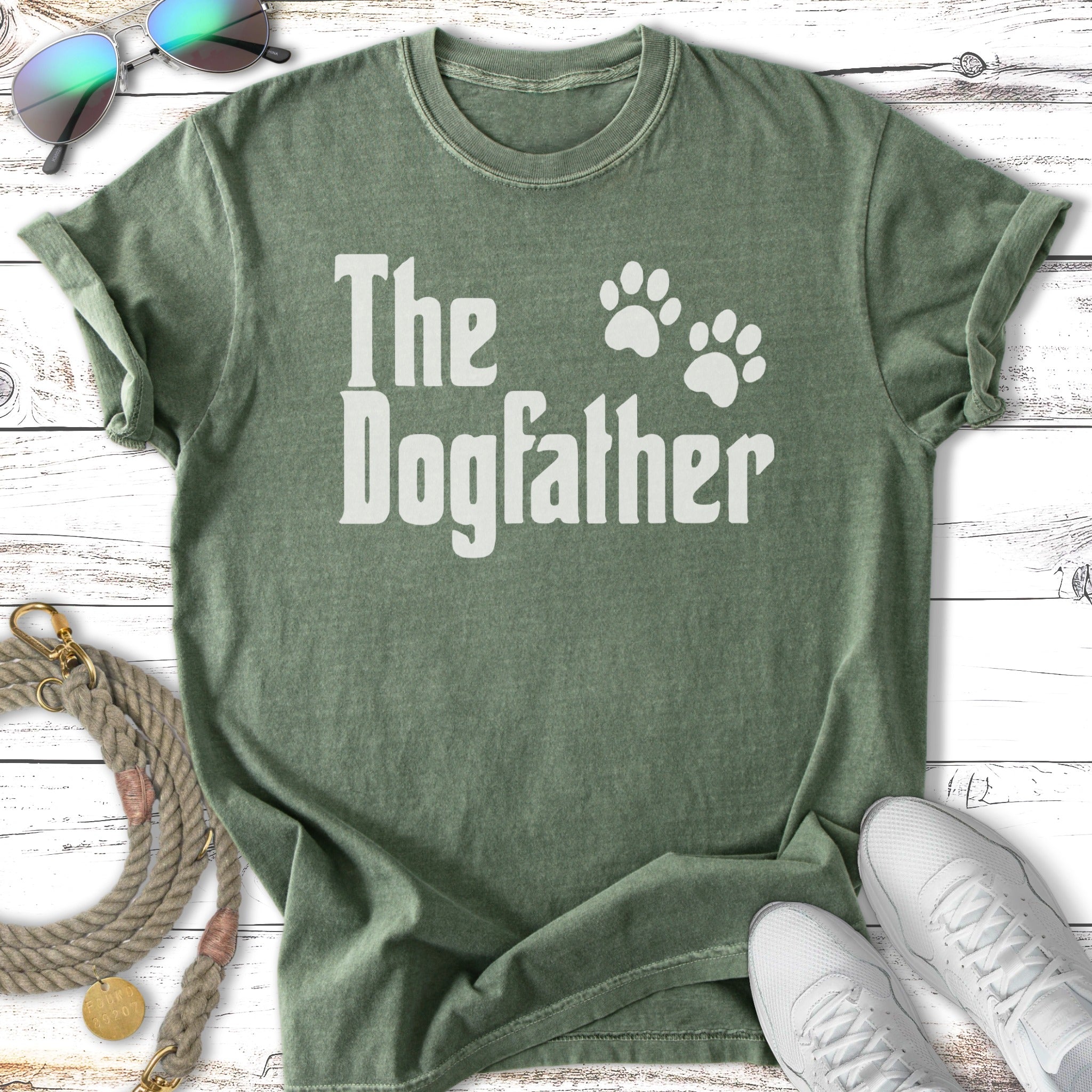 Green t-shirt with white text "The Dogfather" and paw prints.