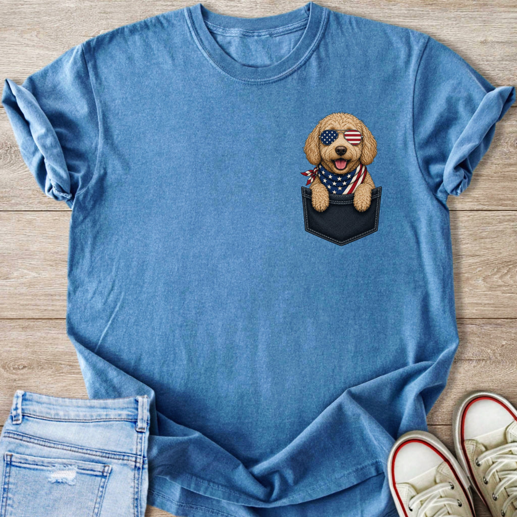 Blue t-shirt with a doodle wearing sunglasses and an American flag bandana in its pocket.