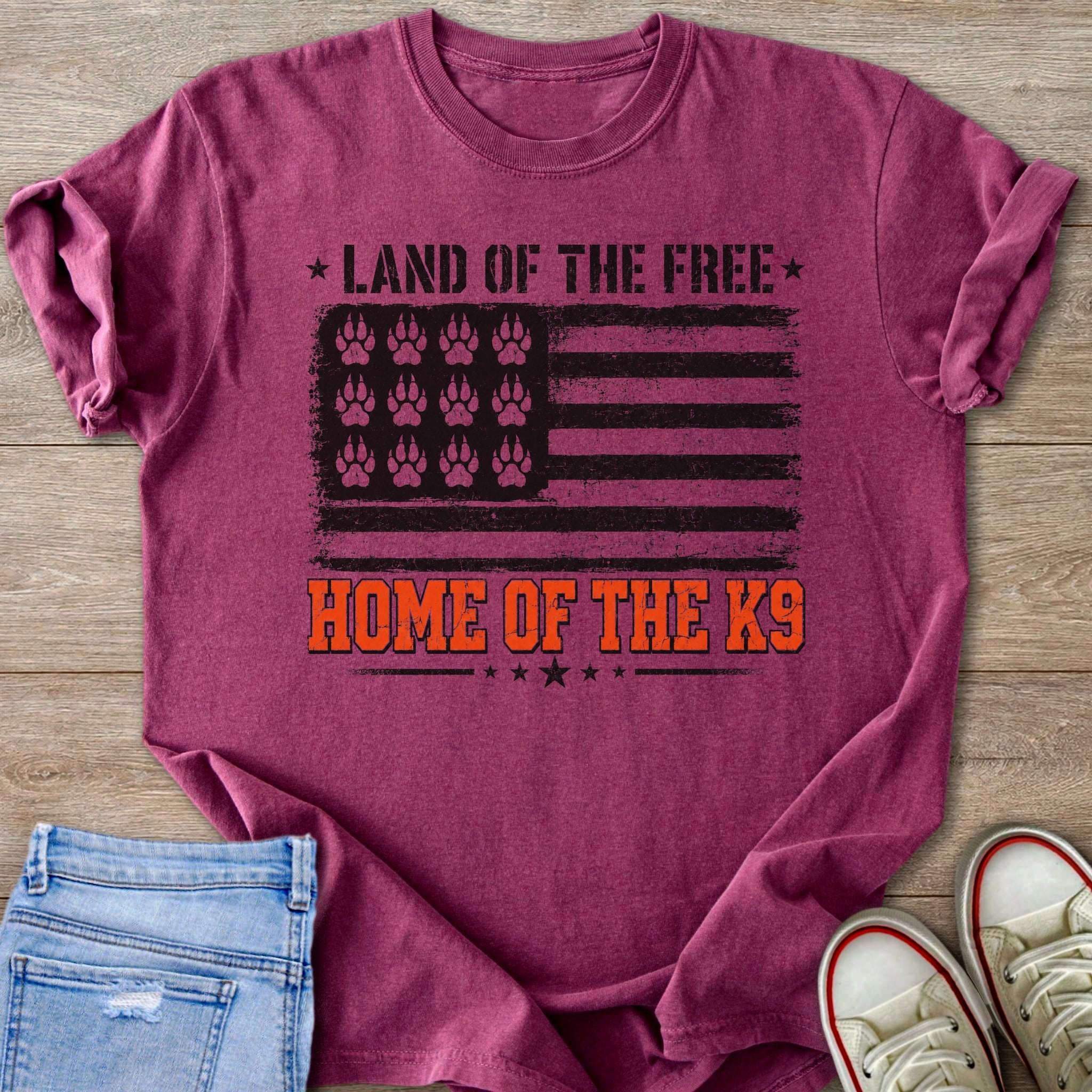 T-shirt with distressed flag design, paw prints, and "Land of the Free Home of the K9" text.