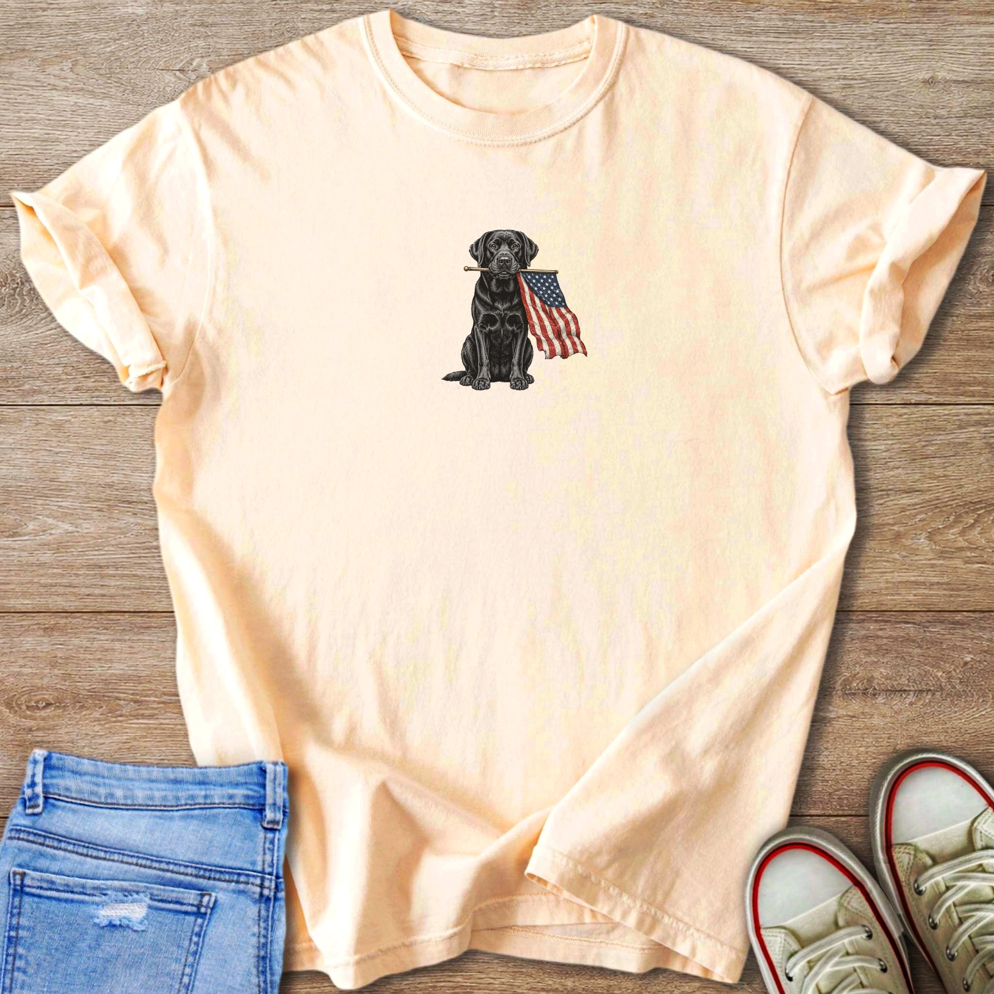 Ivory t-shirt with black dog holding American flag graphic.