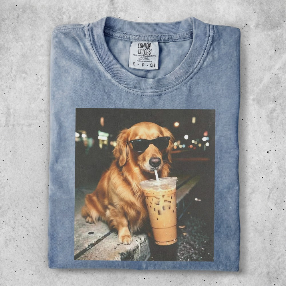 Golden retriever wearing sunglasses drinks iced coffee.