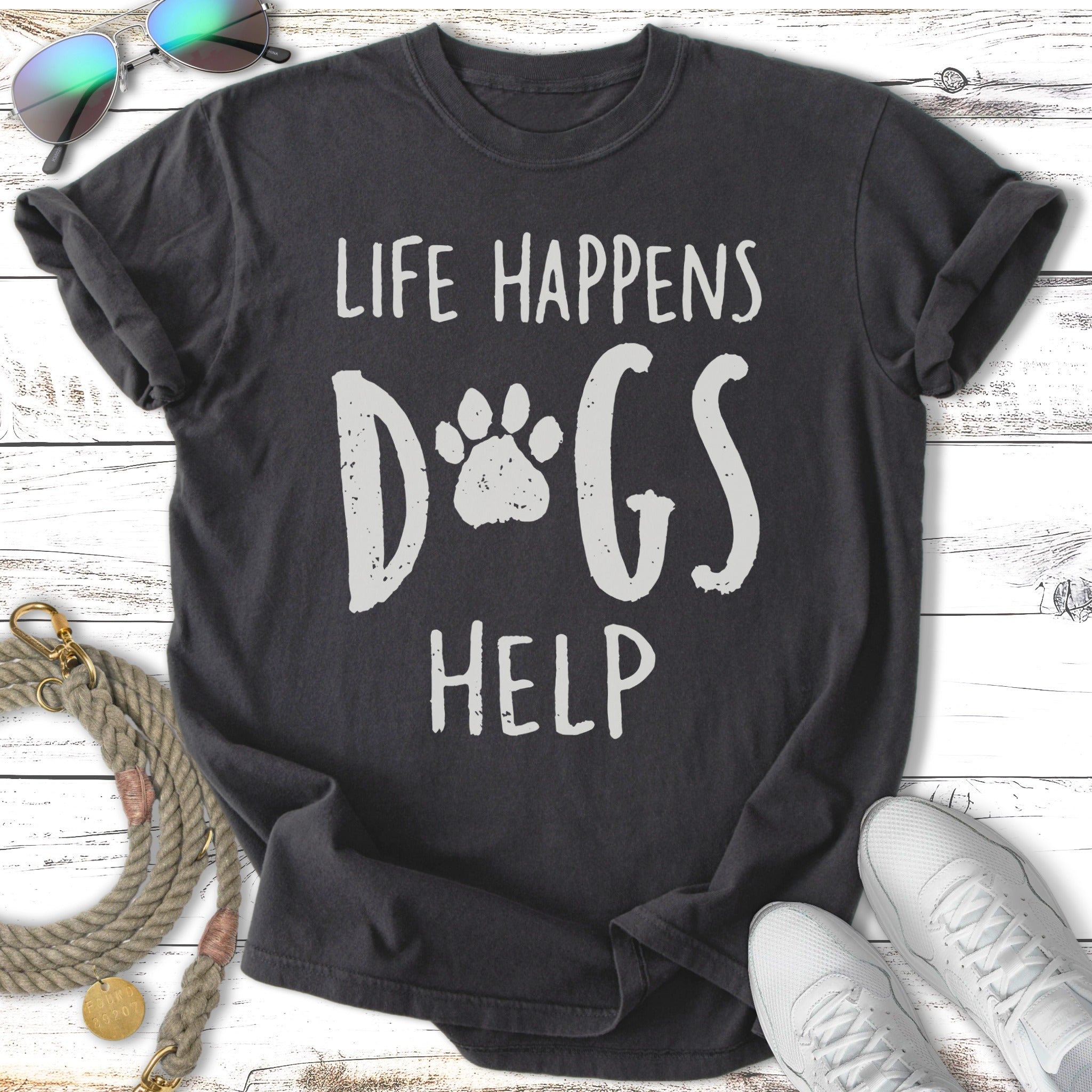 Dark gray t-shirt with white text "Life Happens Dogs Help" and a paw print.
