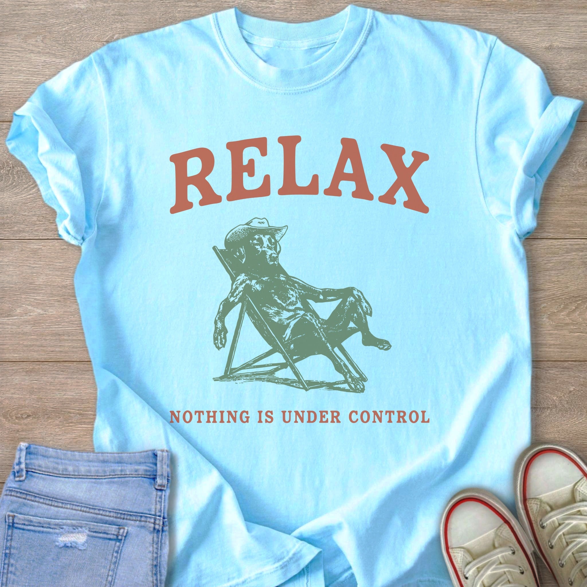 Light blue t-shirt with "RELAX" and skeleton in a lounge chair.