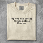 Cream t-shirt with "My dog has better social skills than me" text.