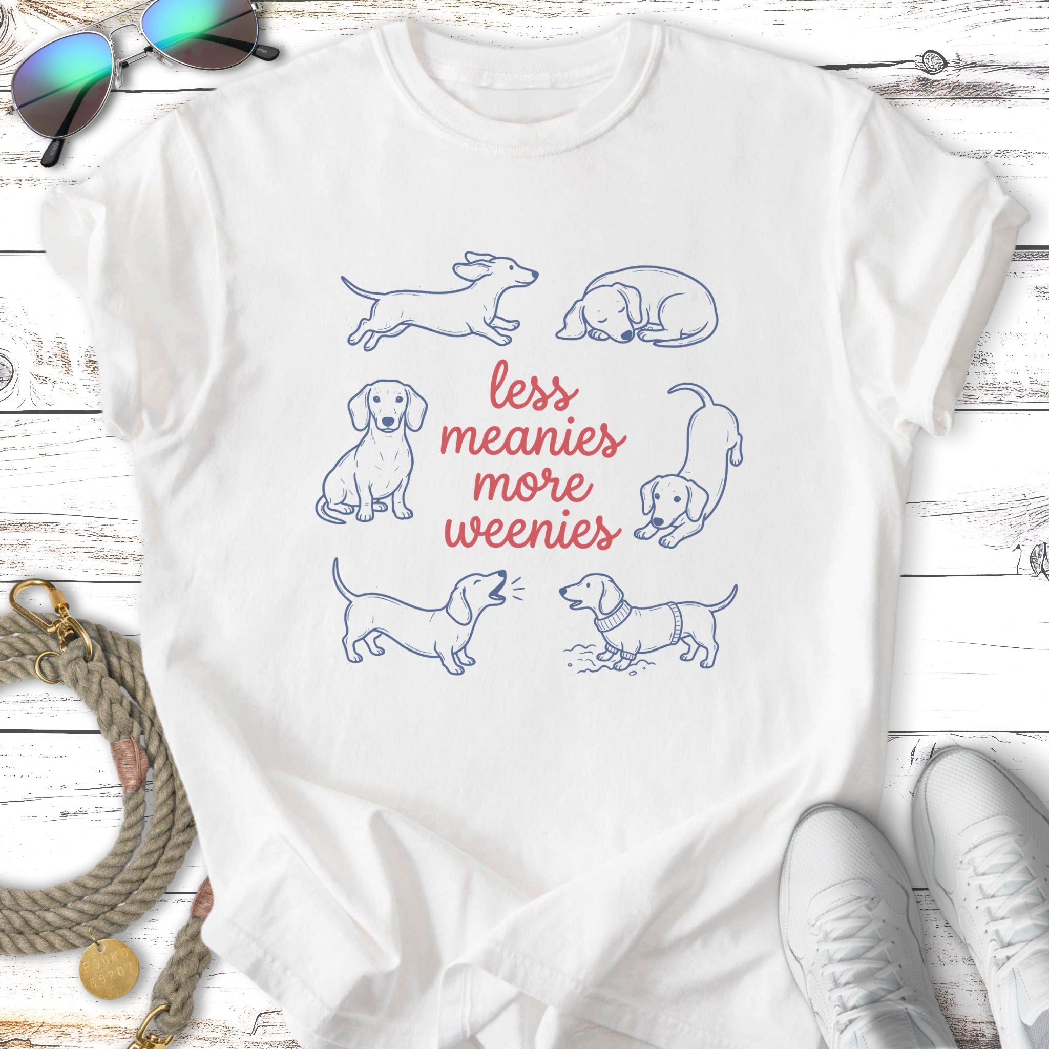 T-shirt with outline drawings of dachshunds and text "less meanies more weenies".