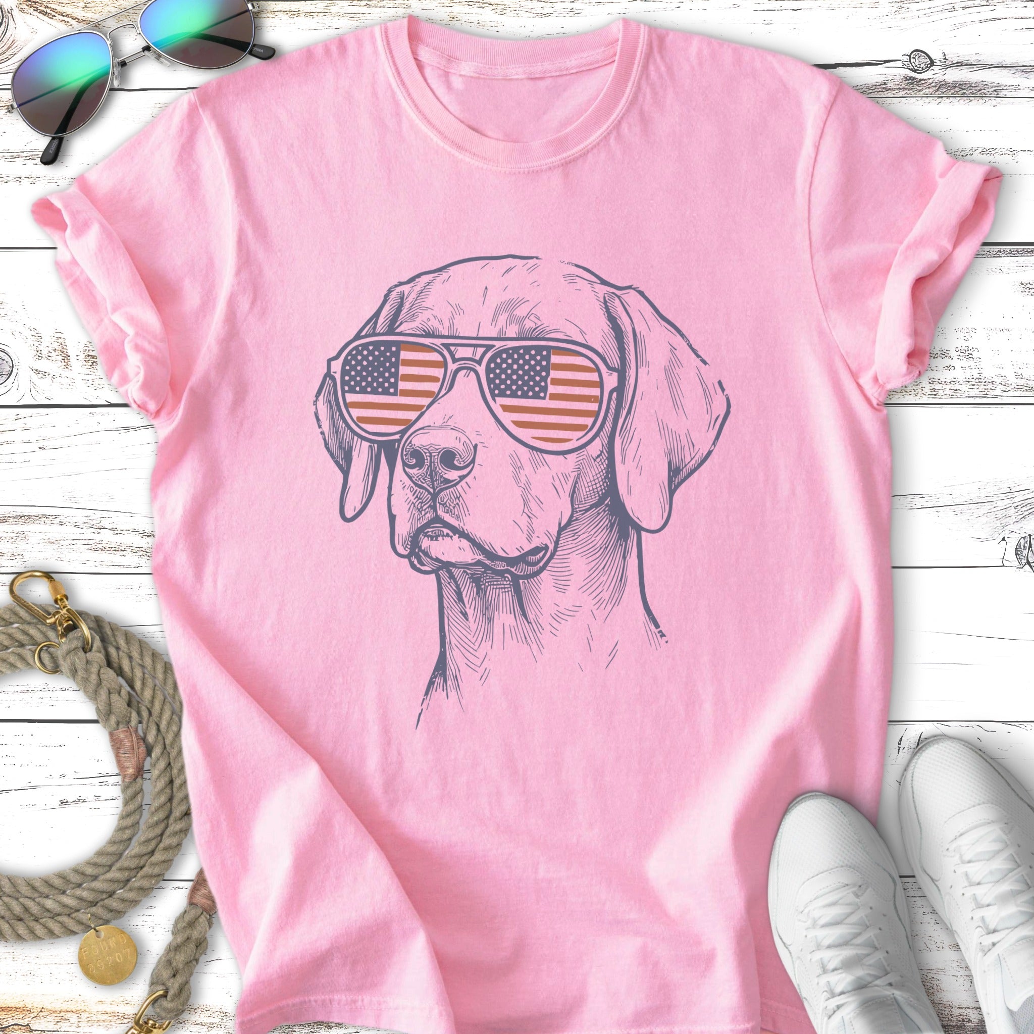 Line drawing of a dog wearing sunglasses with an American flag design.