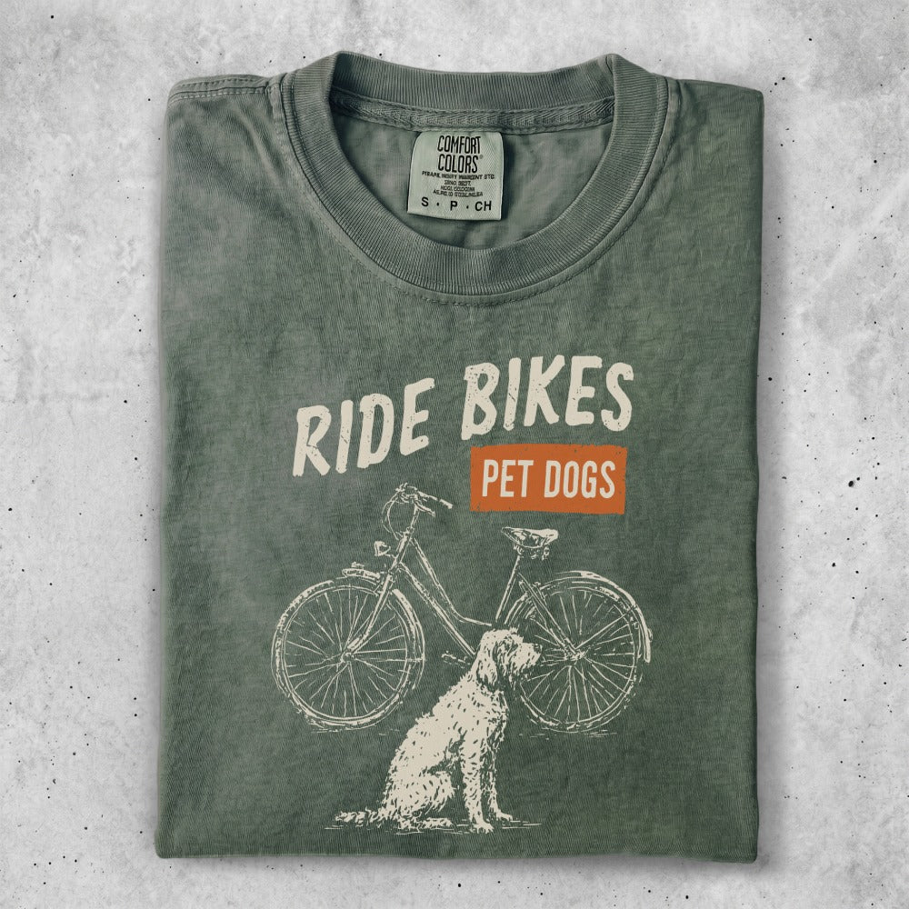 T-shirt with "Ride Bikes Pet Dogs" text and illustrated dog and bicycle.