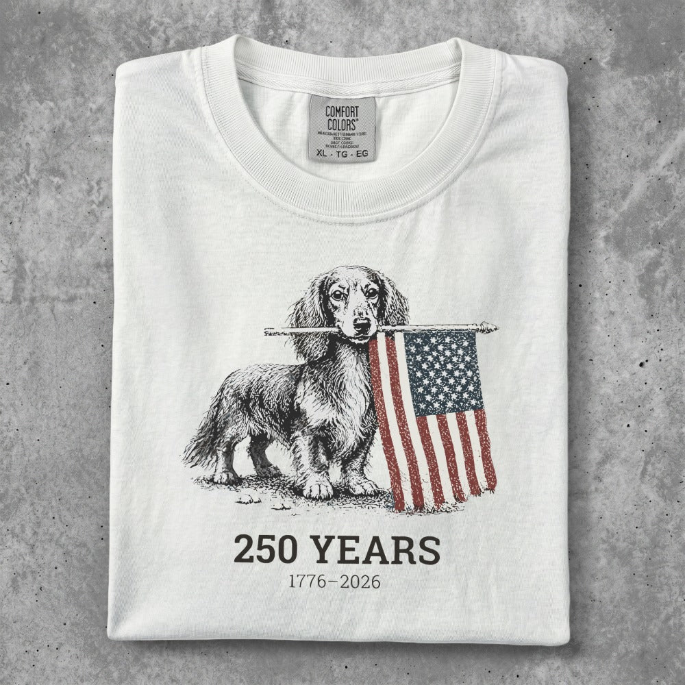 Dachshund holding American flag with "250 Years 1776-2026" text.